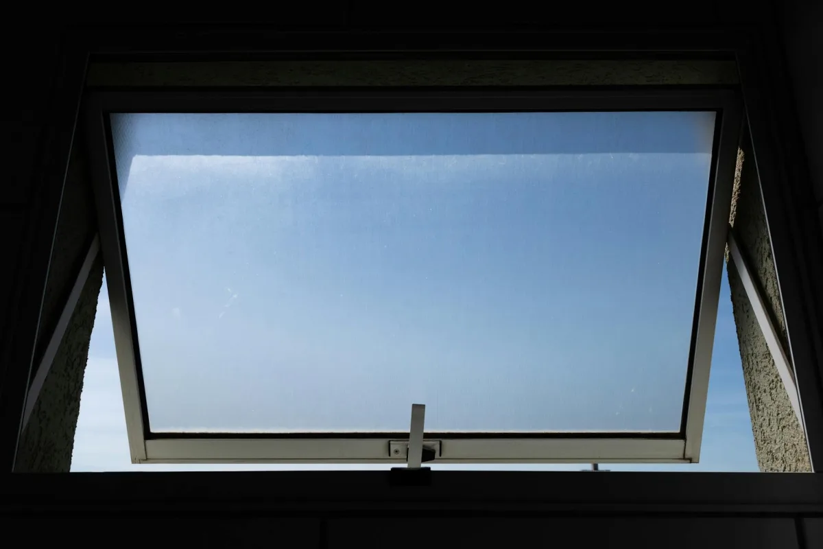 A cross-section of a home showing window cracks, an HRV unit, an open interior door, and a Terrestream sensor on a wall.