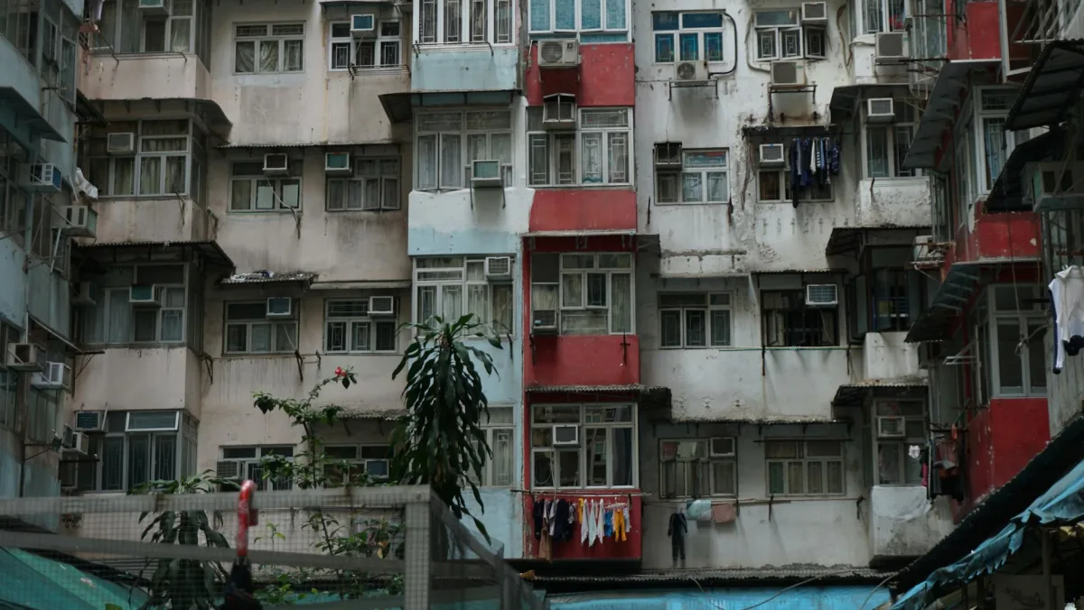 A small modern apartment with a window open onto a city street.
