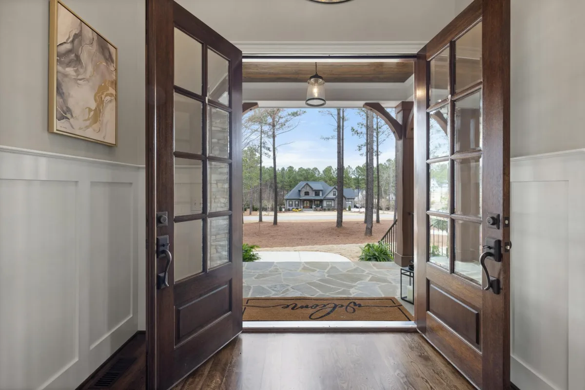A front door opened onto a quiet sunlit hallway.