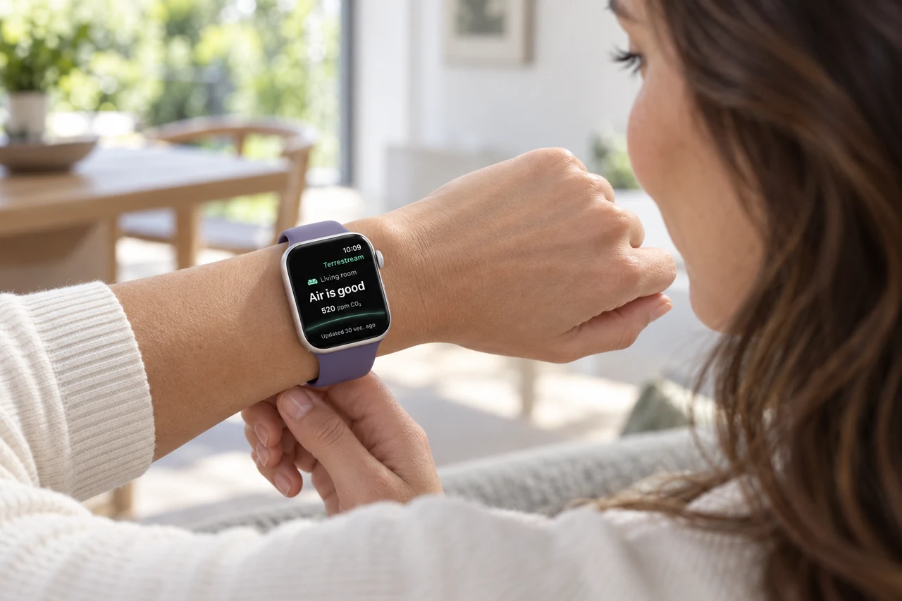 Alex checking room air readings on her Apple Watch, viewed over her shoulder